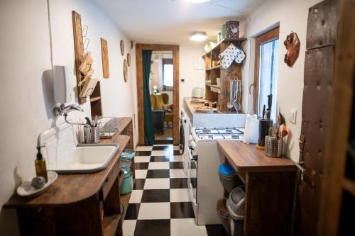 a kitchen with a checkered floor and a sink at Libling Štiavnický in Banská Štiavnica