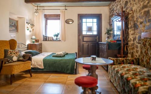 a bedroom with a bed and a table and a couch at Libling Štiavnický in Banská Štiavnica