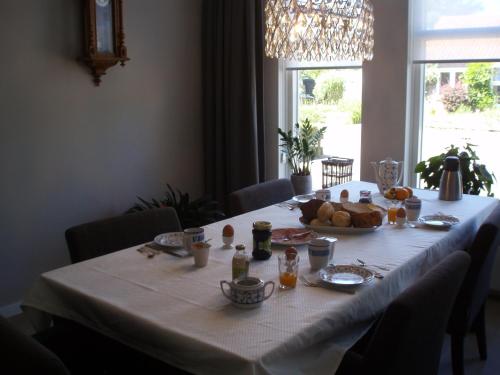 a table with a plate of food on it at B&B Fam. Tavenier in Vrouwenpolder