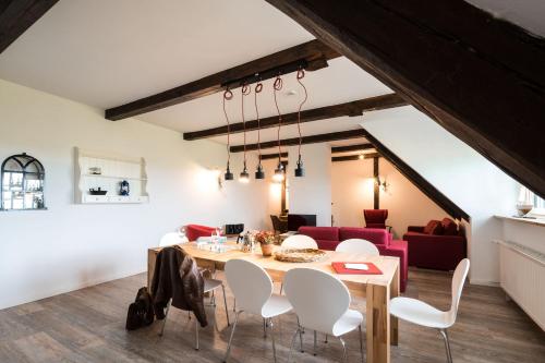 a dining room with a table and white chairs at HW App 9 in Welt