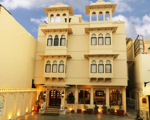 a large white building with two towers at Boheda Palace in Udaipur