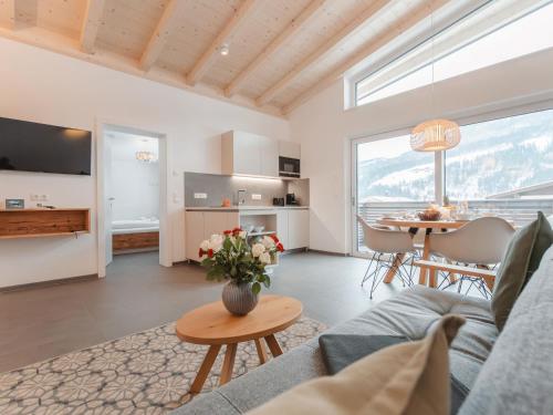 a living room with a couch and a table at Apartment Das Georgen- Kitzsteinhorn by Interhome in Fürstau