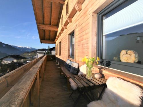a balcony with benches and a large window at Apartment Hannah Lena by Interhome in Wiesing
