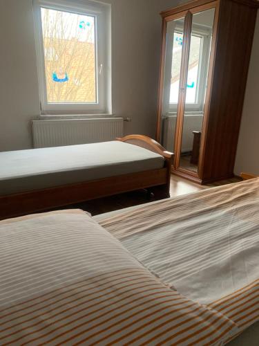 a bedroom with two beds and a window at CASA MIA in Einbeck