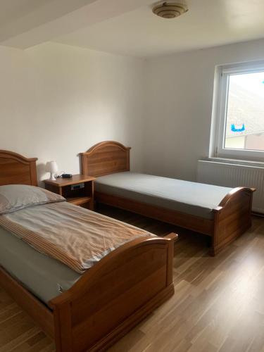 a bedroom with two beds and a window at CASA MIA in Einbeck