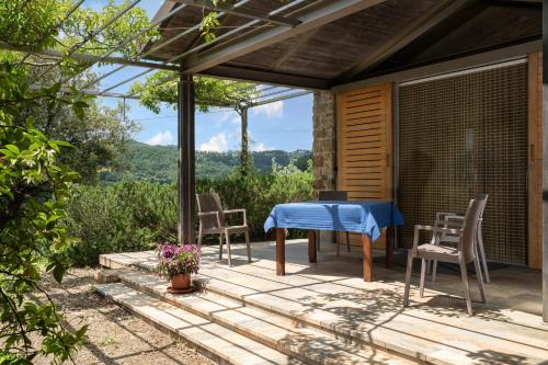 a patio with a blue table and chairs at Panama in Roccatederighi