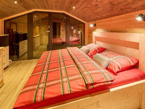 a bedroom with a bed in a wooden cabin at Chalet Lux chalet by Interhome in Mladé Buky
