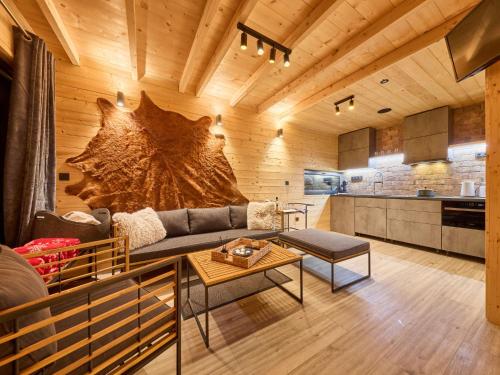 a living room with a couch and a table at Chalet Lux chalet by Interhome in Mladé Buky