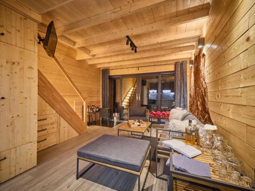 a living room with wooden walls and wooden floors at Chalet Luxe Timber Lodge & Pet Retreat by Interhome in Mladé Buky