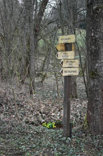 a wooden sign in the woods with signs on it at Chalet Luxe Timber Lodge & Relaxing Bath by Interhome in Mladé Buky