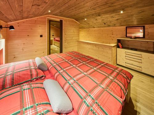 a bedroom with a bed in a wooden room at Chalet Luxe Timber Lodge & Pet Retreat by Interhome in Mladé Buky