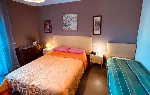 a bedroom with a bed with two pink pillows at Violet Home Irpinia in Montemarano