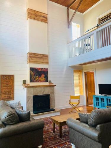 a living room with two couches and a fireplace at Triple Brick on Main in Wyalusing