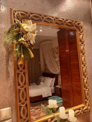 a large mirror in a room with a bed at Casa da Sogno Elegant Studio in Nafpaktos