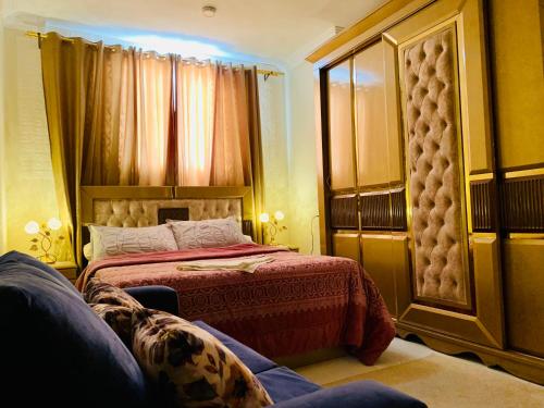 sypialnia z łóżkiem i kanapą w obiekcie LOAY PYRAMIDS VIEW w Kairze