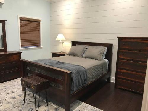a bedroom with a bed and a dresser at The Cast Iron Lady in Wyalusing