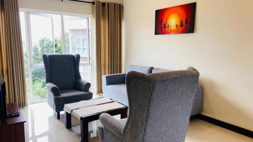 a living room with two chairs and a table at Bluewind Luxury Apartment - 2rooms - Wattala-Hemas Hospital in Wattala