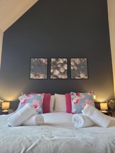 a bedroom with a large white bed with four pillows at Stay @ The Old Bank, Burton on Trent in Burton upon Trent