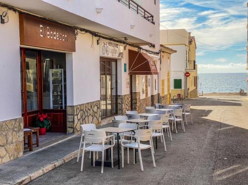 a row of tables and chairs outside of a building at Hostal Ca'n Pep in Sa Ràpita