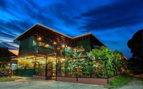 a house with lights in front of it at LArtista Hostel in Puerto Princesa City