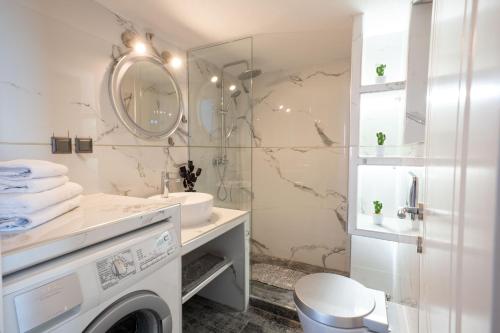 a bathroom with a sink and a washing machine at F & B Collection - Seaview 2 Bedroom Flat in Thessaloniki