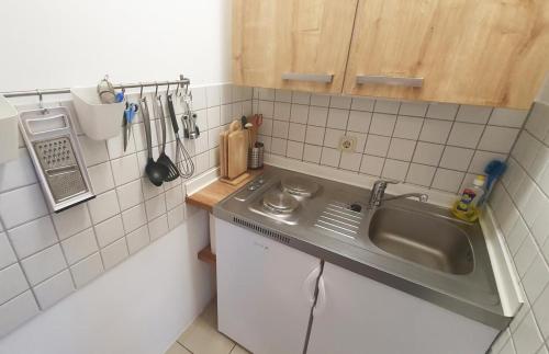 a small kitchen with a sink and a counter at Hanni, wenige Minuten zum Strand in Warnemünde