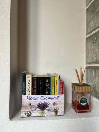 a book exchange shelf with books on it at DaLu Florence apartment Davide - private car park 15 minutes to the city center in Florence