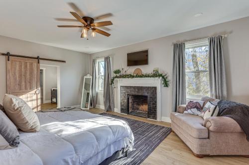 a bedroom with a bed and a couch and a fireplace at Pet-Friendly Shelbyville Home with Fire Pit! in Shelbyville