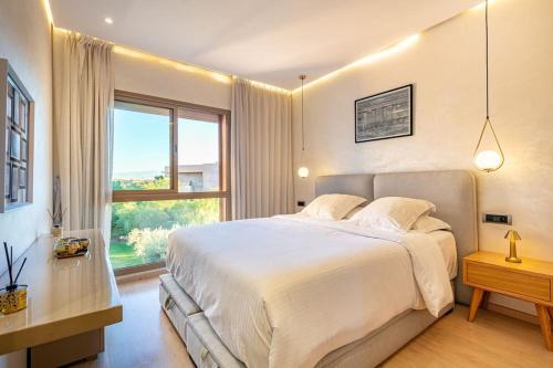 a bedroom with a large bed and a large window at PO 10 by Majestic Properties in Marrakech