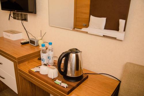バクーにあるSolo Hotelの- ホテルの部屋のデスクの上のお茶ポット