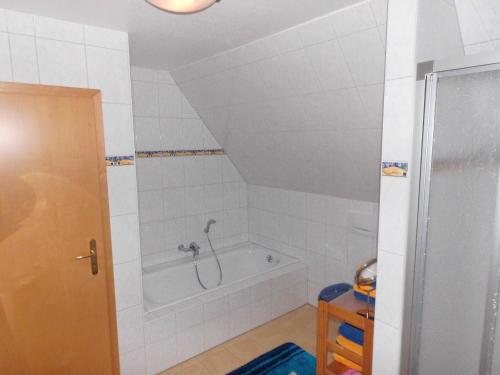 a bathroom with a bath tub in a attic at Hus Boock in Tönning