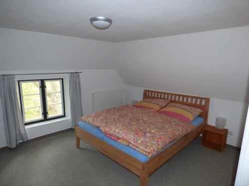 a bedroom with a bed and a window at Wasserkoog 22 in Tetenbüll