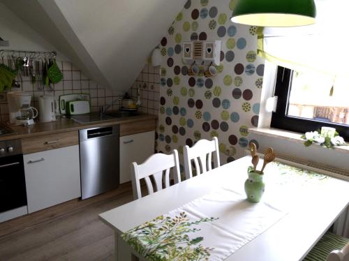 eine Küche mit einem weißen Tisch und einem Esszimmer in der Unterkunft Ferienwohnung Dernbecher in Saarbrücken