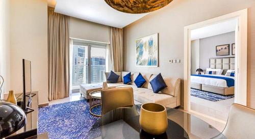 a large living room with a bed and a couch at Luxury Hotel Apartment - DownTown in Dubai