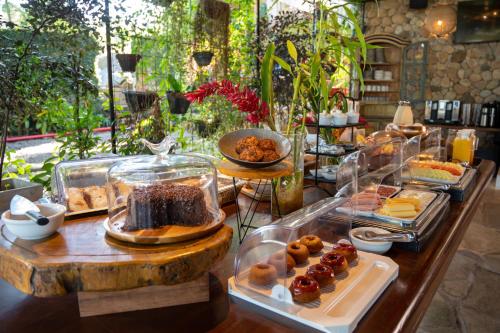 a buffet with different types of food on a table at Hotel Velas do Engenho in Ilhabela
