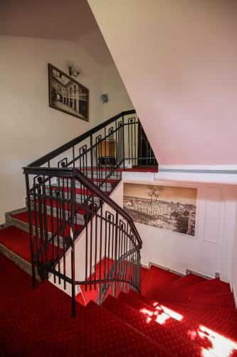 a spiral staircase in a room with red carpet at Villa 1927 in Belgrade