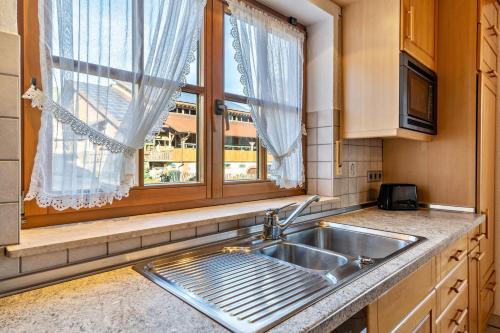 a kitchen with a sink and a window at Wanglerhof Familie Wangler in Schuttertal