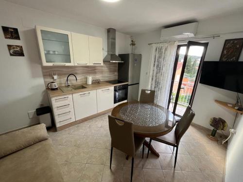 a kitchen with a dining room table and a kitchen with at Apartment Seman in Vela Luka