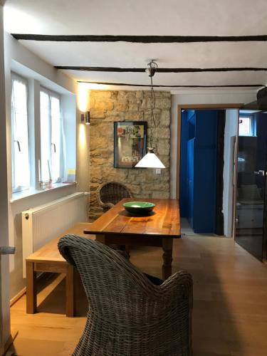a dining room with a wooden table and chairs at Fuxbau in Neustadt an der Weinstraße