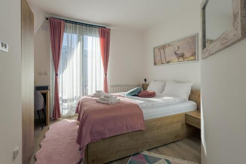 a bedroom with a bed and a large window at Casa Valley Paradiso - Jahorina in Jahorina