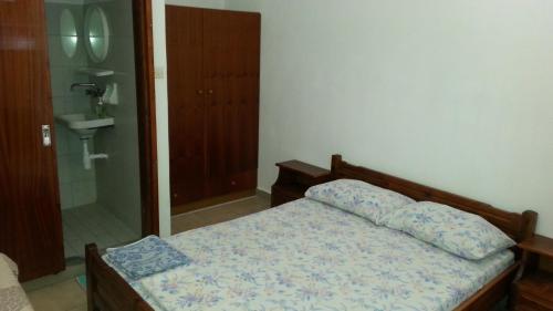 a bedroom with a bed and a walk in shower at Marina's Rooms in Lipsoi