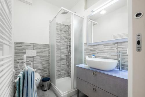 a bathroom with a white sink and a toilet at A casa da nonna Elisa in Castel del Piano