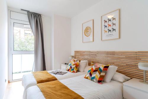 a bedroom with two beds and a window at 4207 - AB Sant Adria de Besos in Barcelona