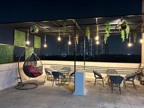 a patio with chairs and tables with a view of a city at Nectar Living - Iris in Hyderabad