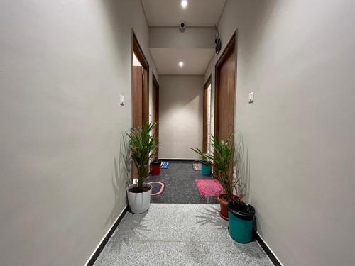 a hallway with potted plants in an office building at Nectar Living - Iris in Hyderabad