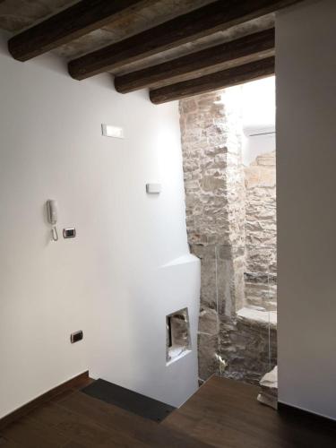a room with a stone wall and a fireplace at Il Torrione in Terlizzi