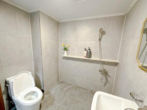 a bathroom with a toilet and a sink and a shower at 8 Hotel in Seoul