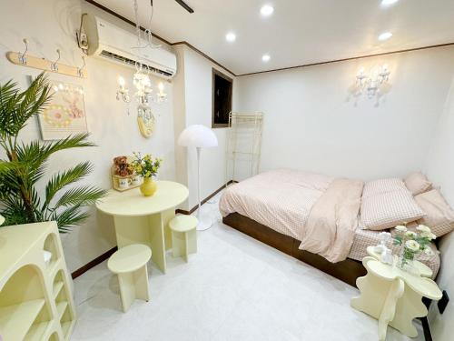 a bedroom with a bed and a table with flowers at 8 Hotel in Seoul