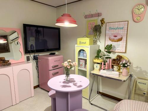 a toy room with a table and a tv at 8 Hotel in Seoul