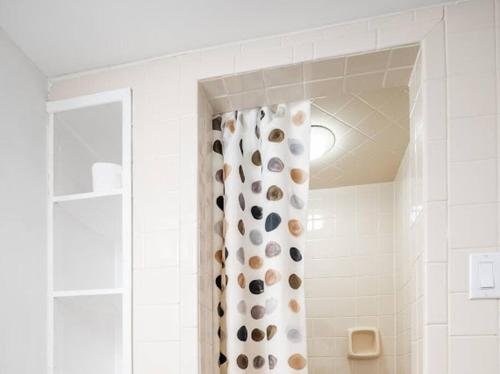 a bathroom with a shower curtain with rocks on it at Gorgeous 4BR House with pool in Mississauga